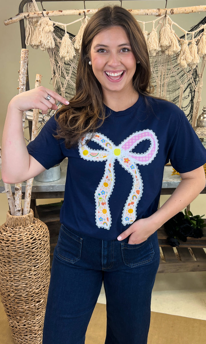 Bright and cheerful Teacher Bow Graphic Shirt featuring a colorful bow design, perfect for educators.