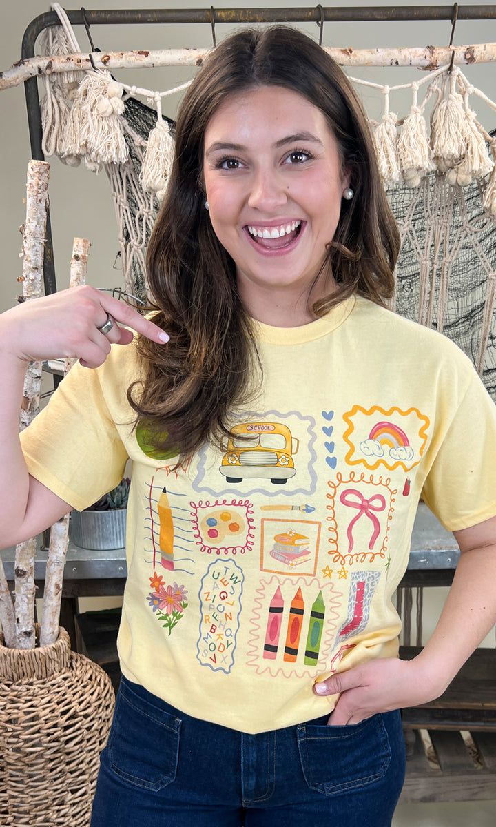 Bright yellow All the Teacher Things Graphic Shirt featuring fun school-themed designs, perfect for educators.