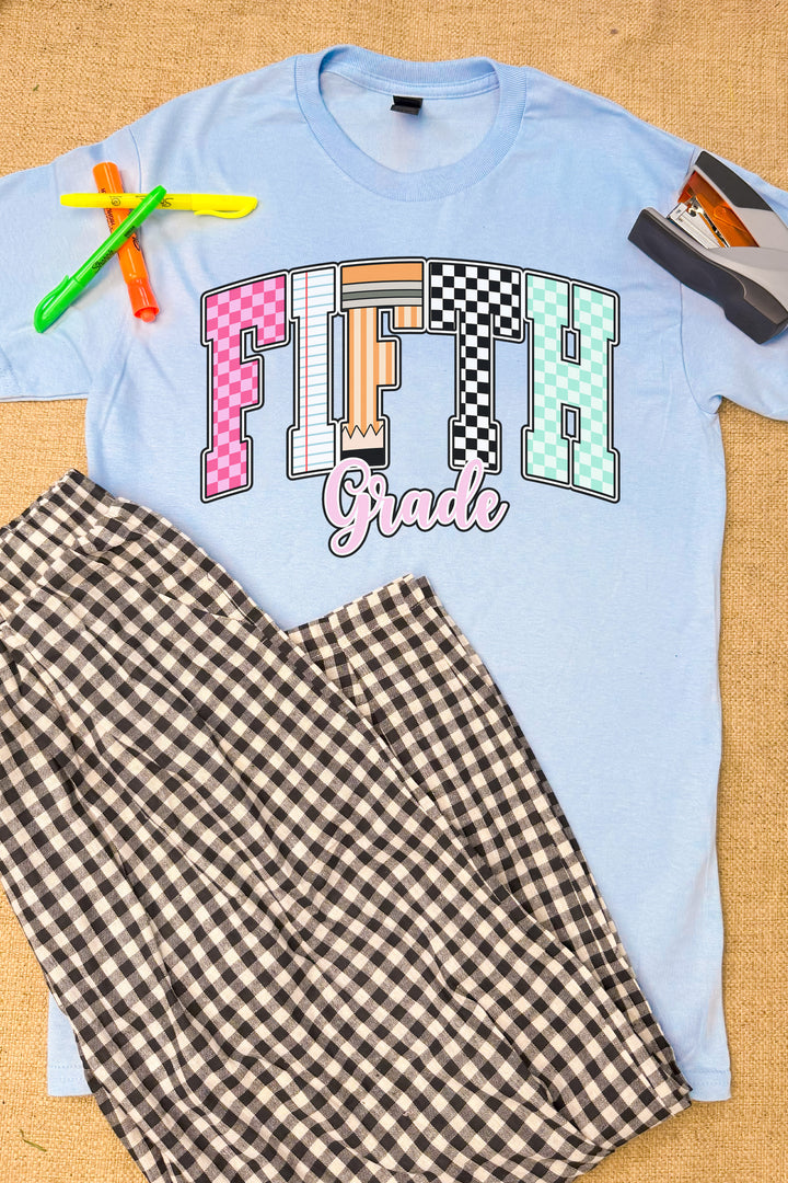 Stylish Checkerboard Grade Level Graphic T-Shirt in light blue, featuring bold "Fifth Grade" design and plaid pants.
