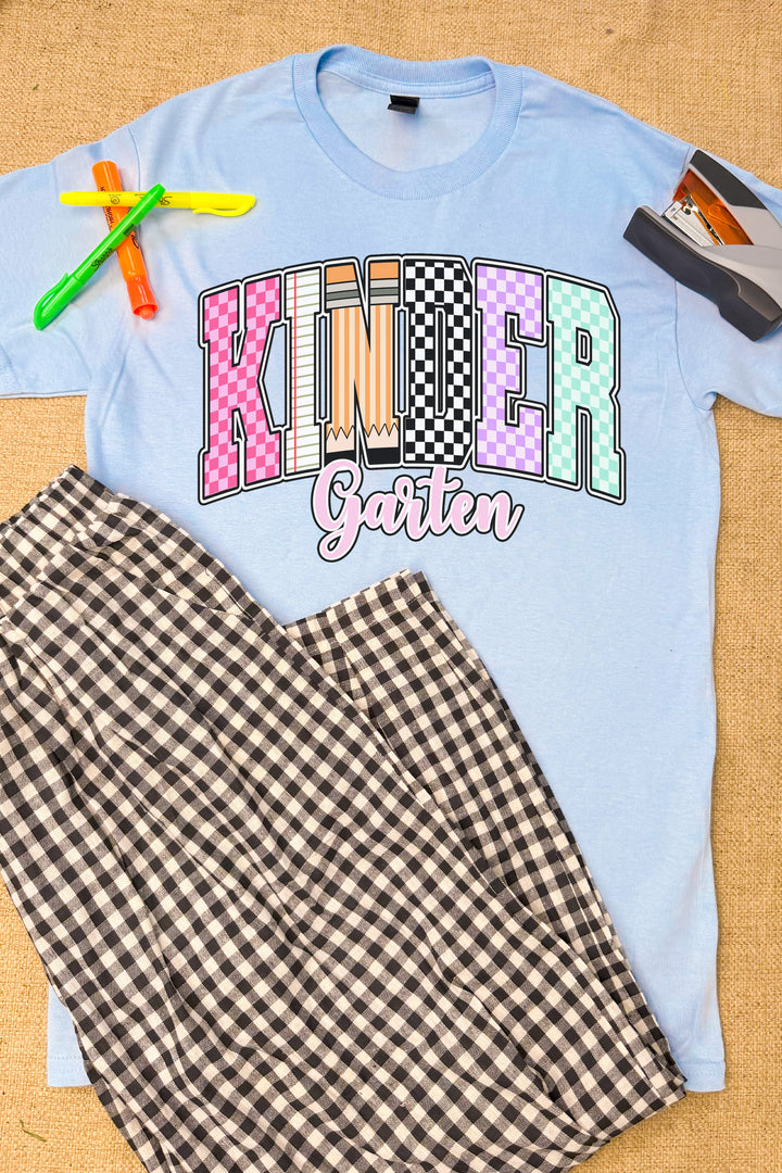 Stylish Checkerboard Grade Level Graphic T-Shirt displayed with plaid pants and school supplies, perfect for kids.