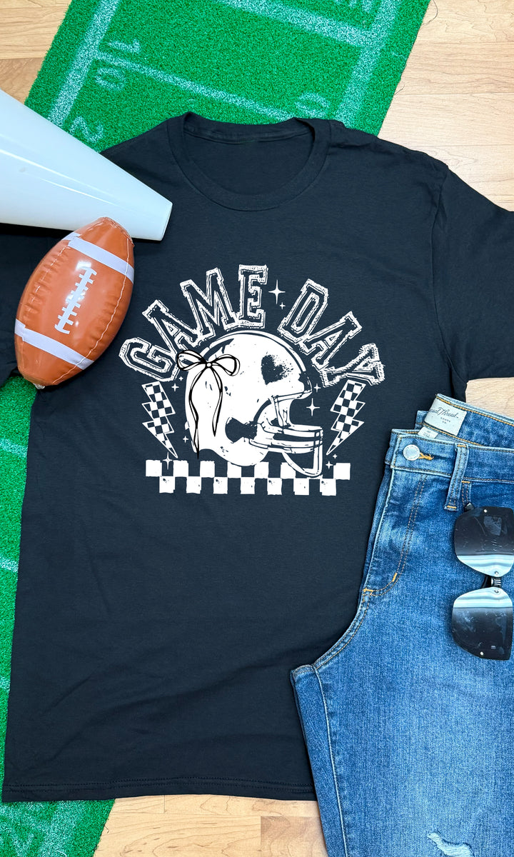 Stylish Game Day Football Bow Graphic T-Shirt on a football-themed backdrop, perfect for game day celebrations.