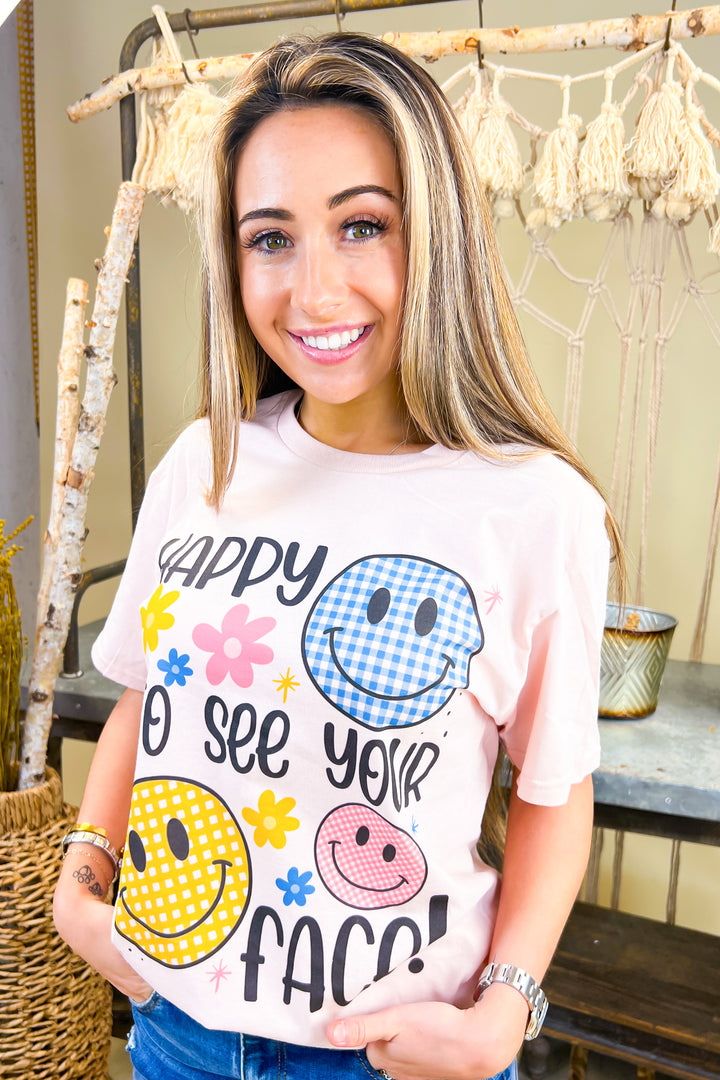 Happy To See Your Face Graphic Shirt features colorful smiley designs, perfect for spreading joy and positivity.
