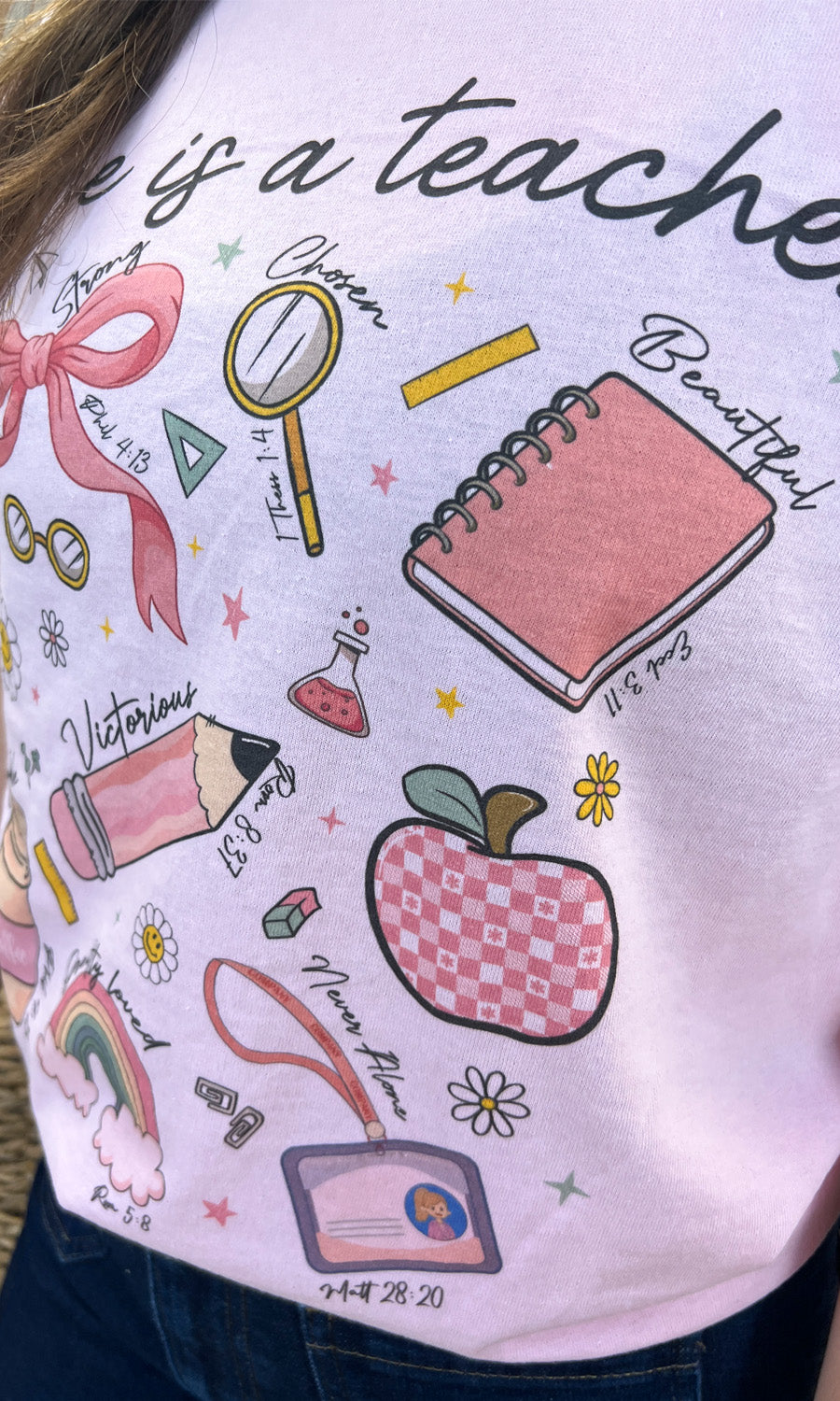 Stylish "She is a Teacher Graphic Shirt" featuring playful school-themed designs, perfect for educators.