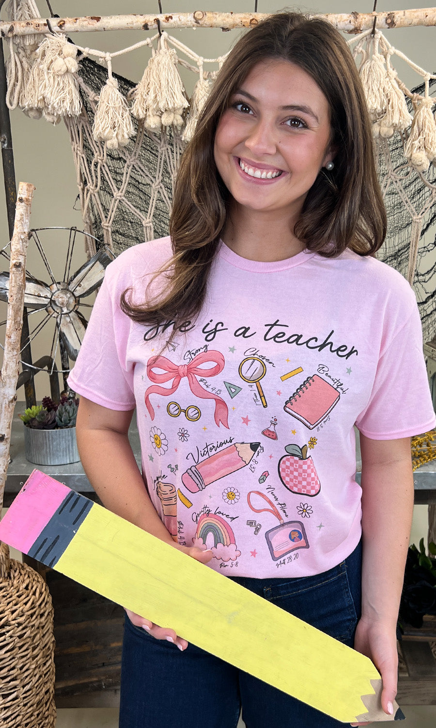 Bright and cheerful, the She is a Teacher Graphic Shirt showcases a fun design perfect for educators.