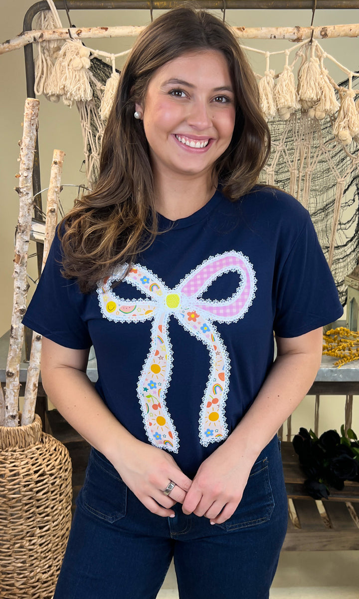 Stylish Teacher Bow Graphic Shirt featuring a colorful bow design, perfect for educators. Ideal for casual wear!