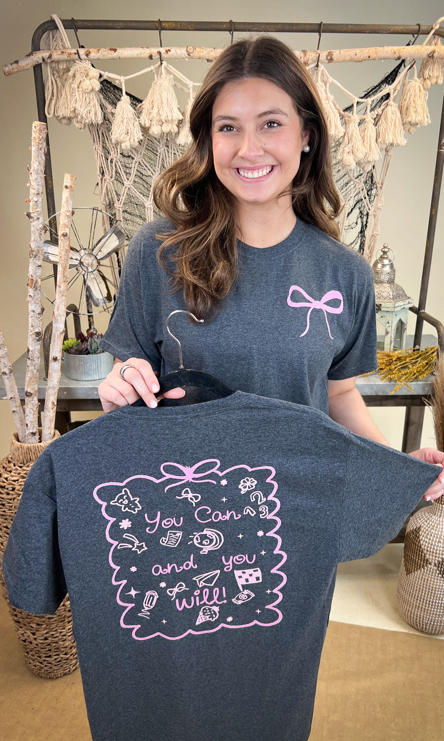 Stylish You Can and You Will Teacher Graphic Shirt displayed by a smiling model, perfect for educators.