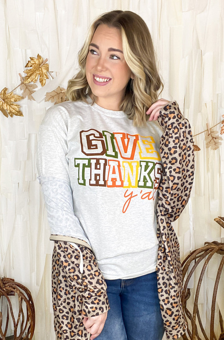 Stylish woman in an ash grey Give Thanks Y'all T-Shirt, perfect for Thanksgiving celebrations.